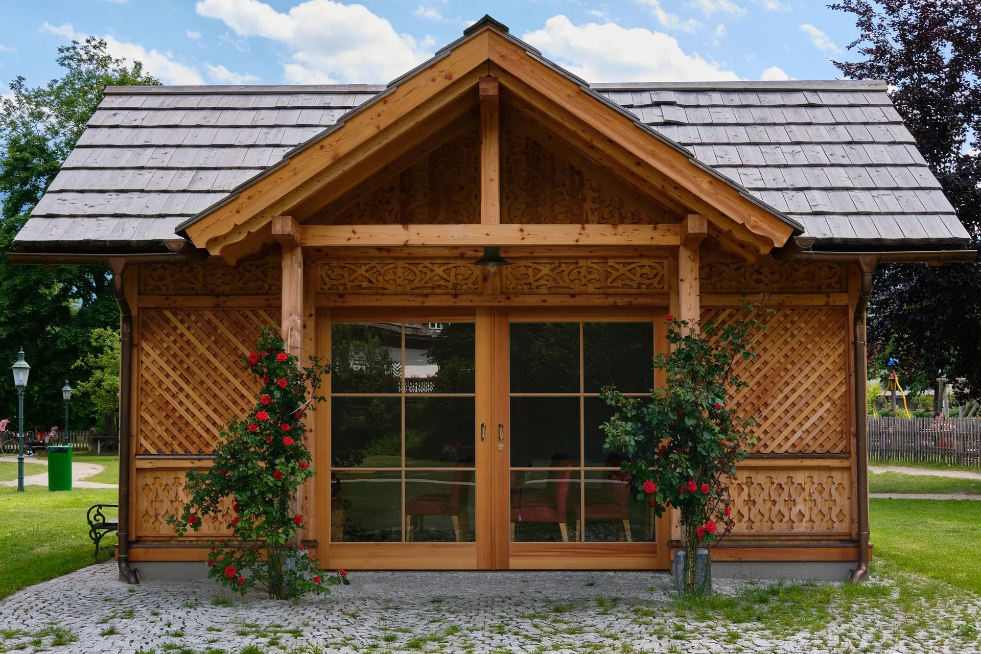 Wooden garden cottage with a pair of glazed doors and lattice panels